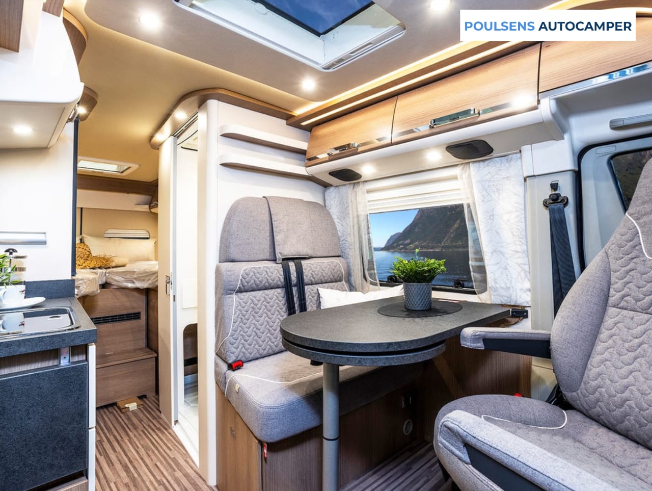 Salon intérieur du camping-car urbain Carthago 640 LE CHARMING GT 2023 avec banquettes et moquette amovible